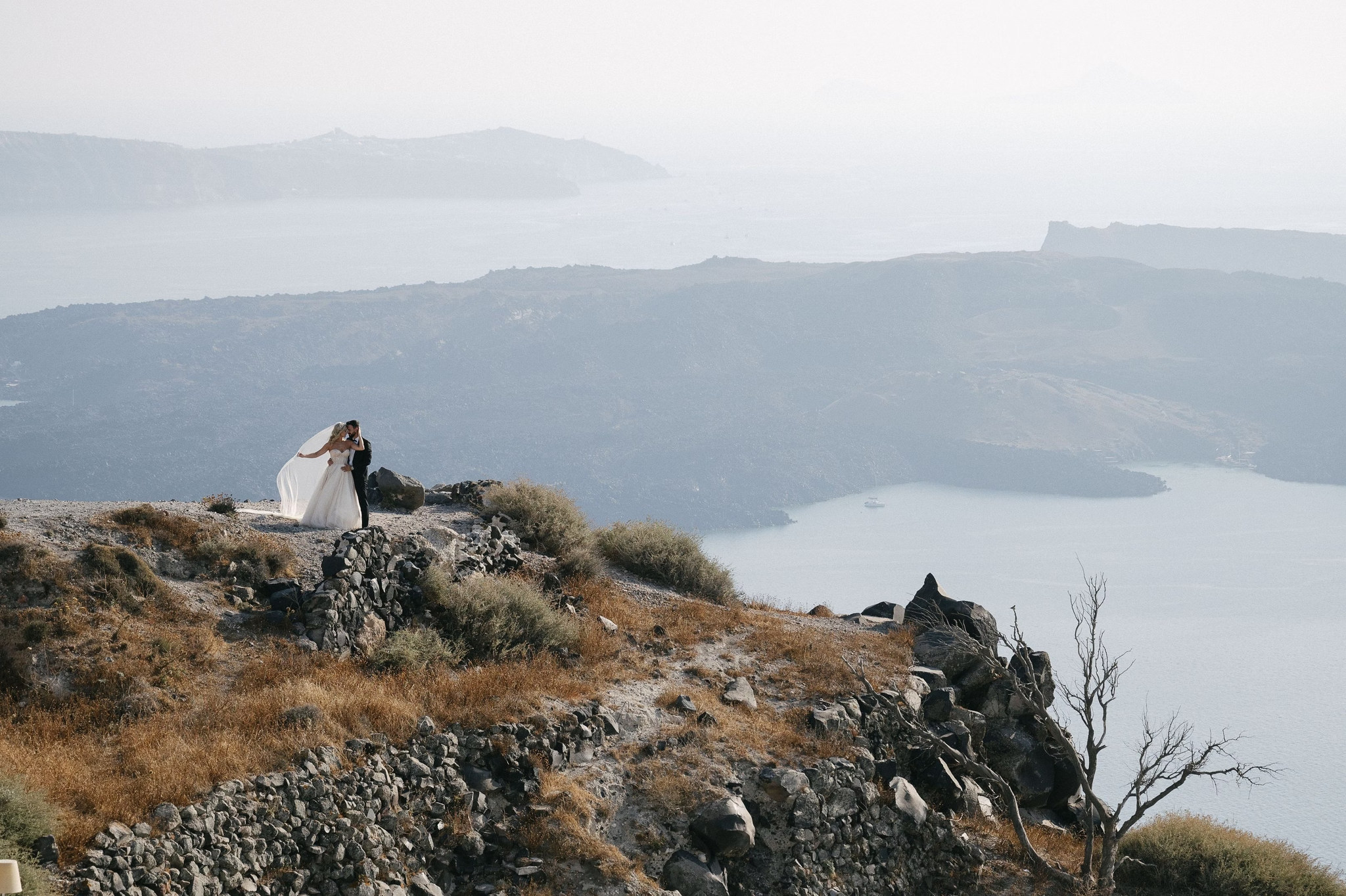 Margi and Nikos during their portrait session above Santorini’s coastline